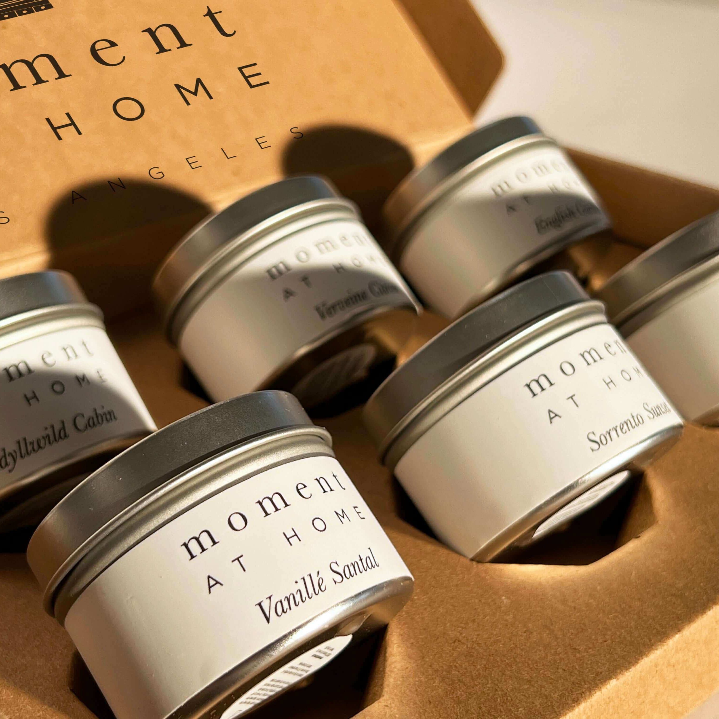 Moment At Home offers custom six mini travel tin discovery candle sets