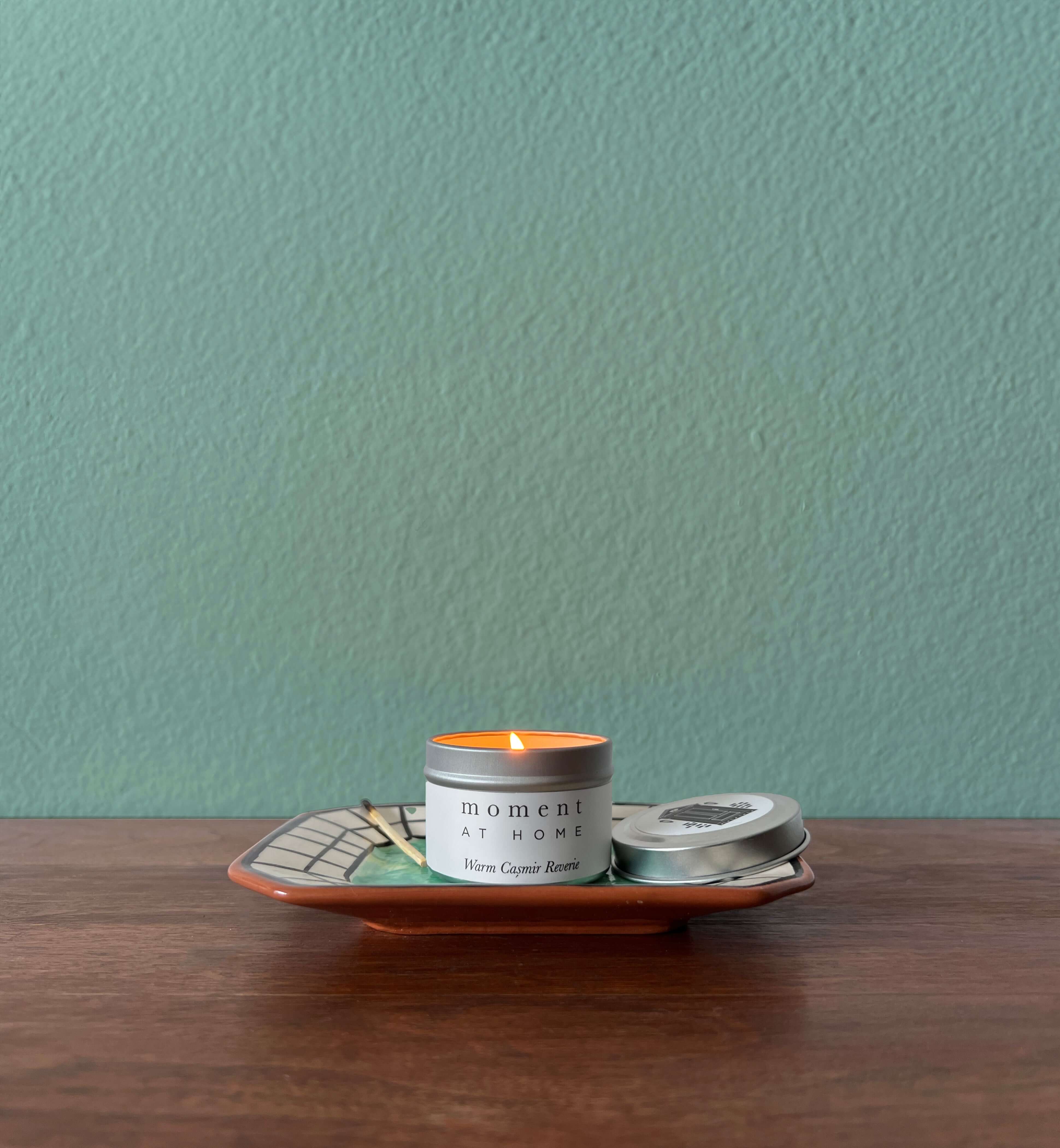 Moment At Home scented mini travel candle on a tray. 
